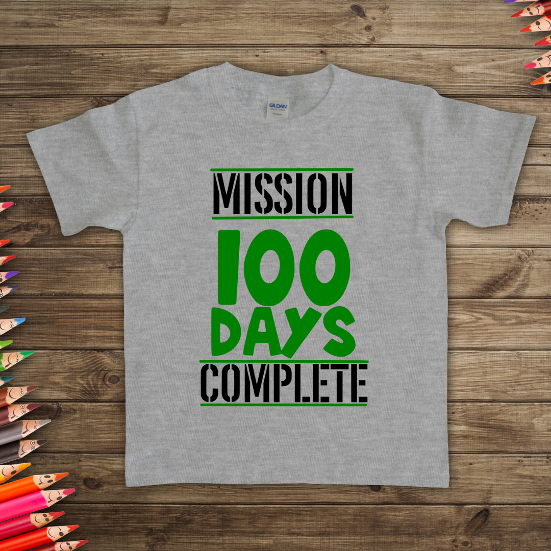 Gray t-shirt on flat lay table with Mission 100 Days Complete text on a wooden surface available in different colors and sizes