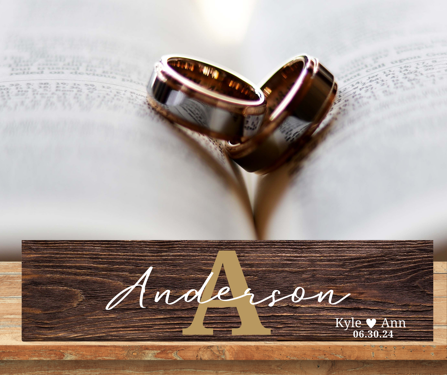 A rustic, 18x6 inch wooden sign with a large engraved monogram and a family name. The sign is propped up on a shelf, showing its natural wood grain and texture