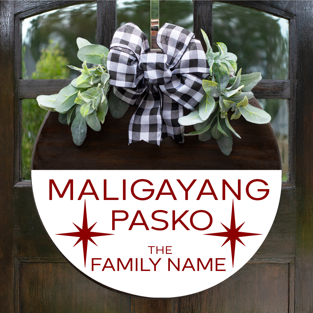 Personalized round Christmas door hanger with "Maligayang Pasko" and custom family name in red font on a white stained background