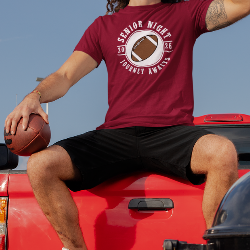 High school quarterback with his maroon Class of 2026 football senior night shirt with Journey Awaits logo and football graphic in white. 