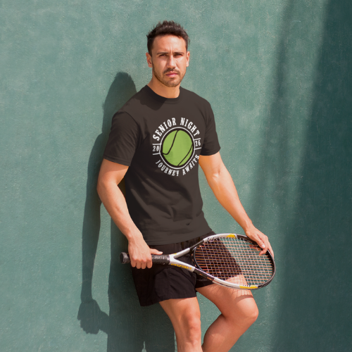 A senior student wearing his 2026 tennis sports night t-shirt with Journey Awaits logo. Available in other colors
