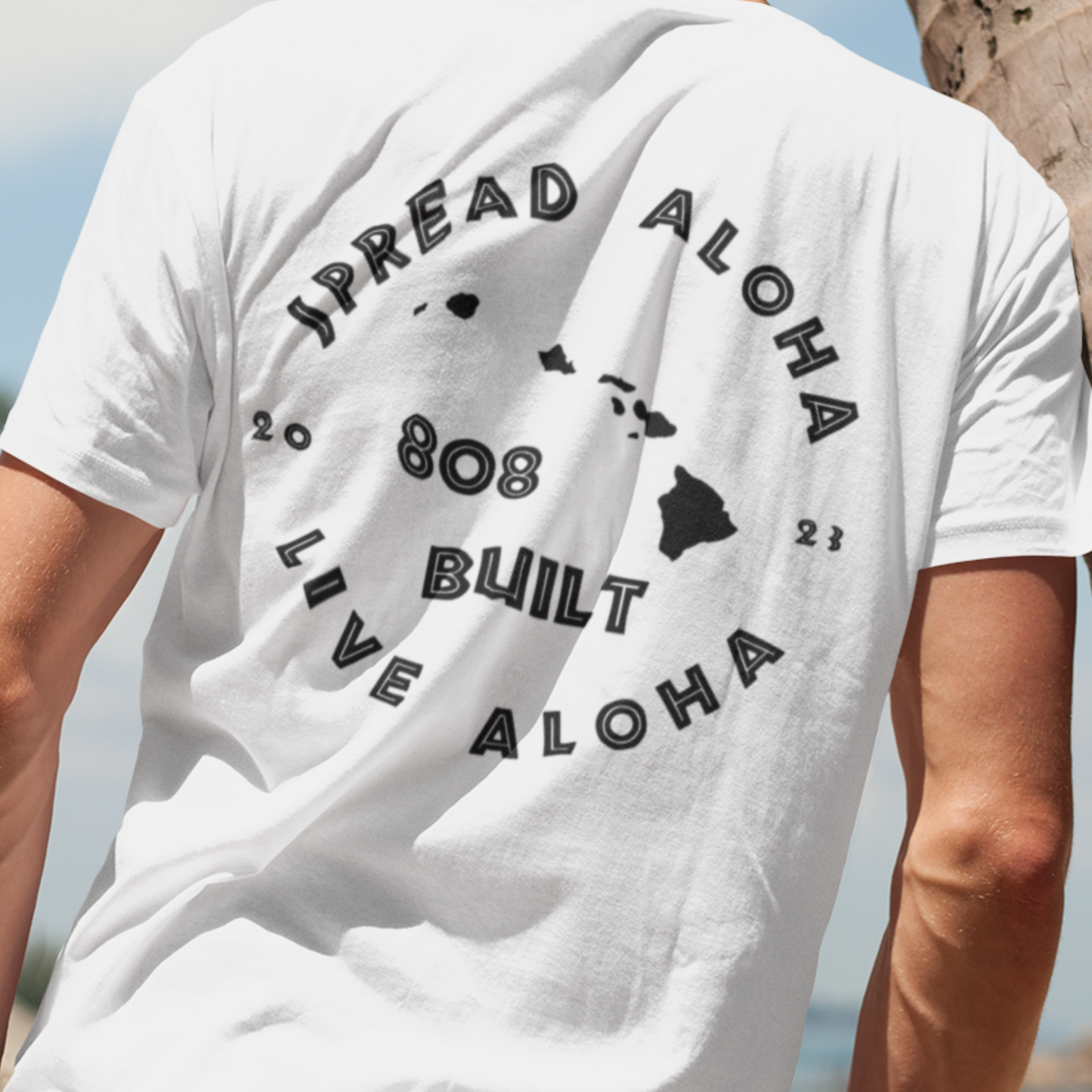 Man wearing the 808 Built Hawaii T-Shirt, which features a double-sided graphic print for local pride, styled for casual wear.

