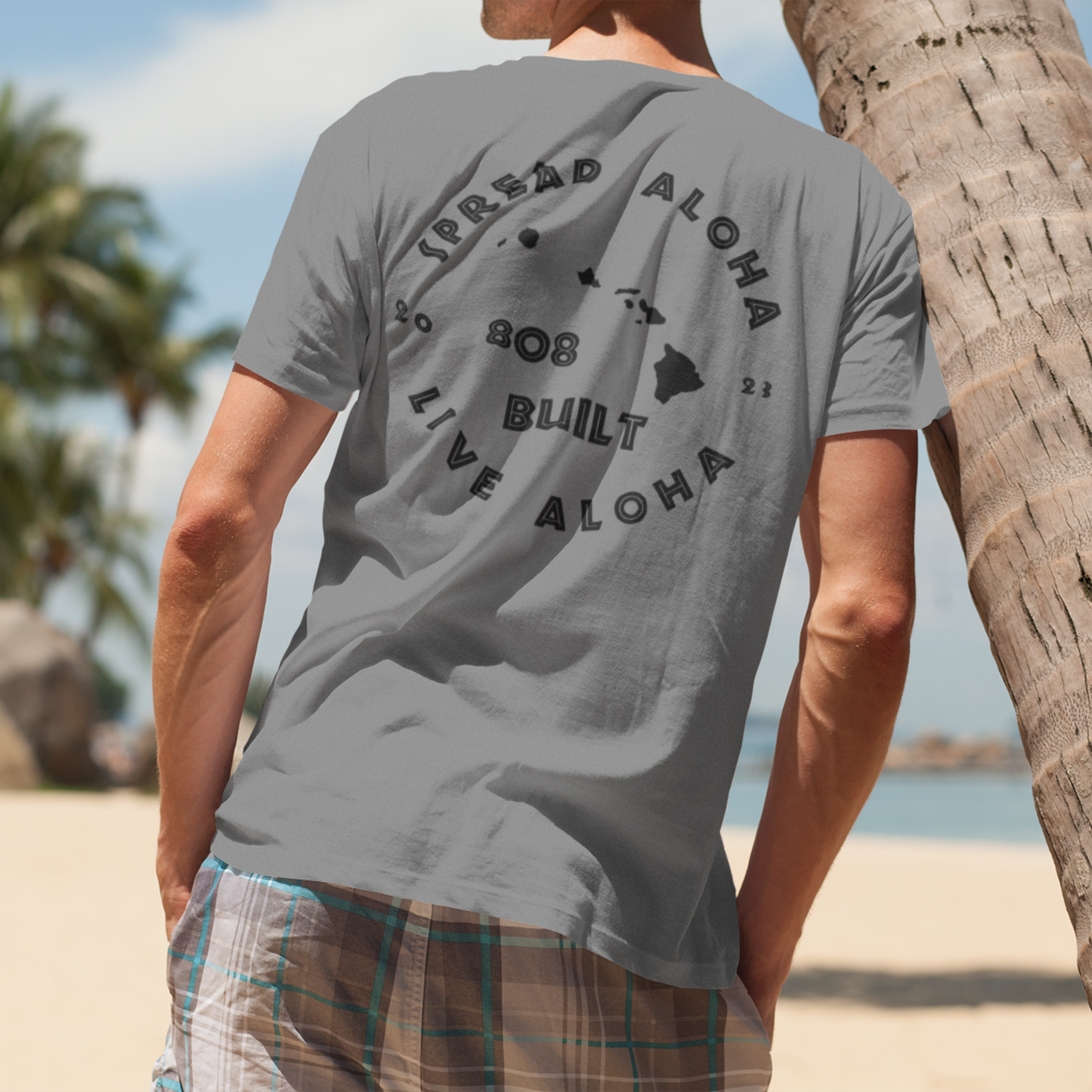 Man wearing the 808 Built Hawaii T-Shirt, which features a double-sided graphic print for local pride, styled for casual wear.

