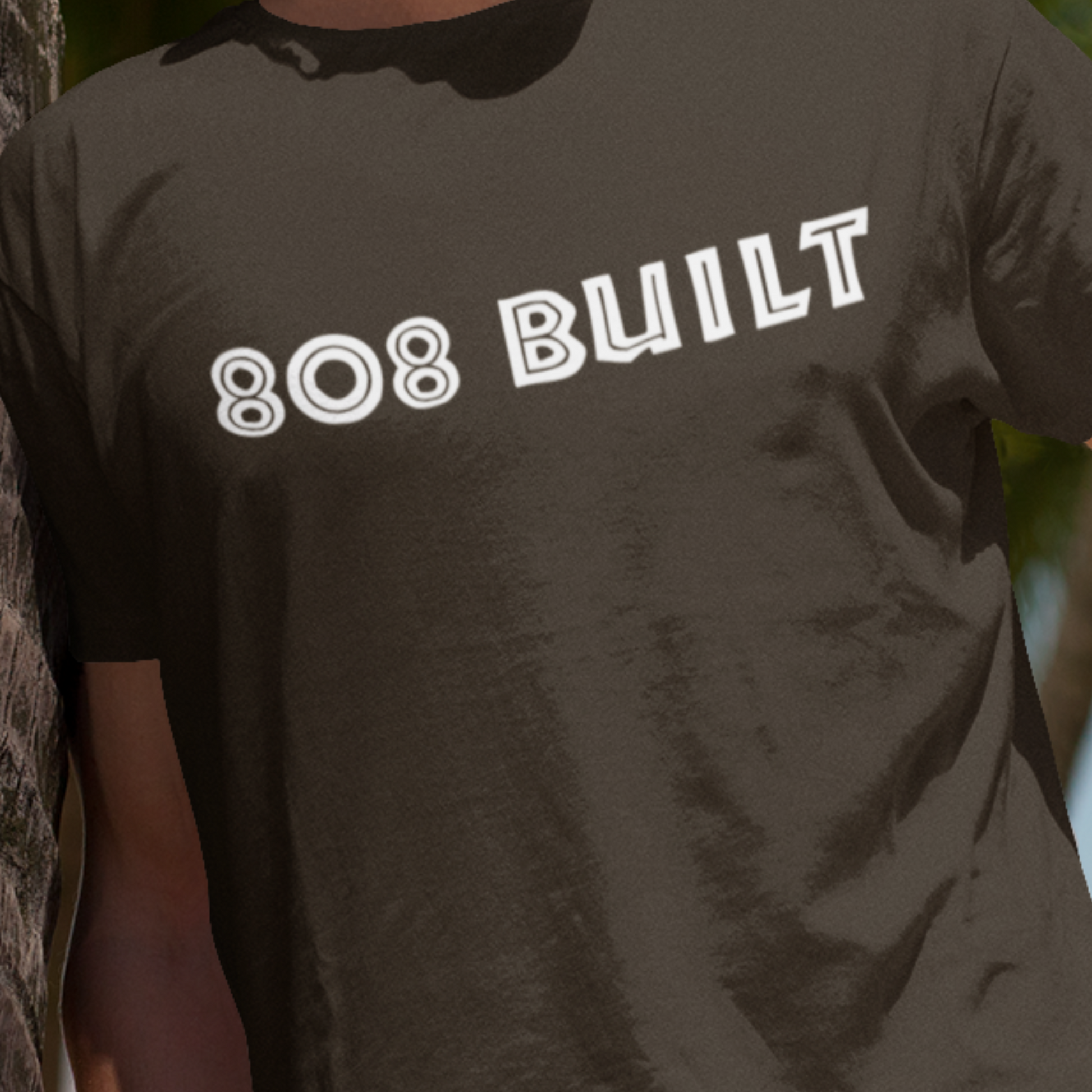 Close up double-sided men's 808 built t-shirt. which features a double-sided graphic print for local pride, styled for casual wear.