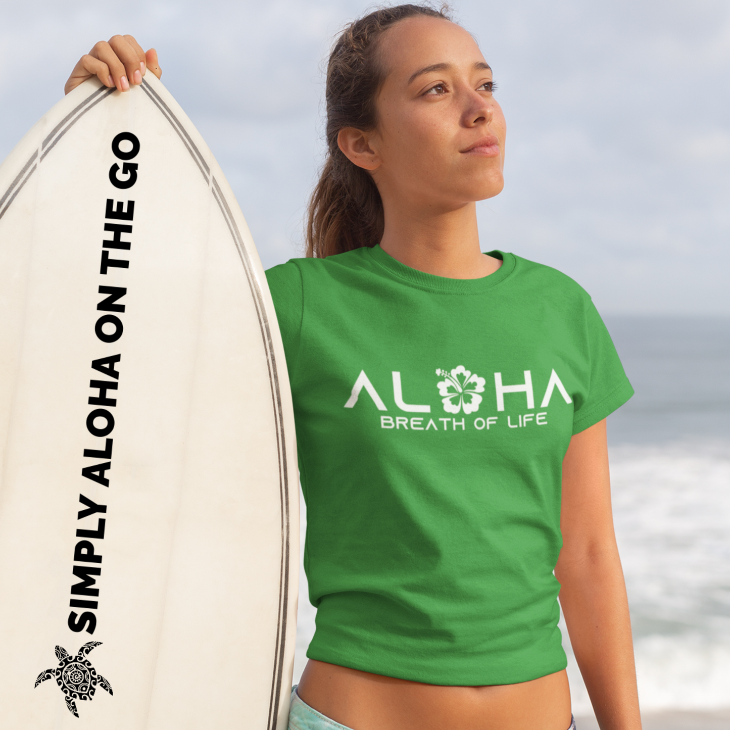 A woman wearing an "Aloha Breath of Life" t-shirt with a hibiscus design, an island-inspired shirt.