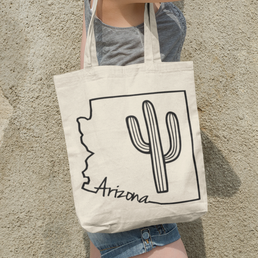 An eco-friendly Arizona tote bag with a cactus featuring a dual-theme design blending desert inspired elements 