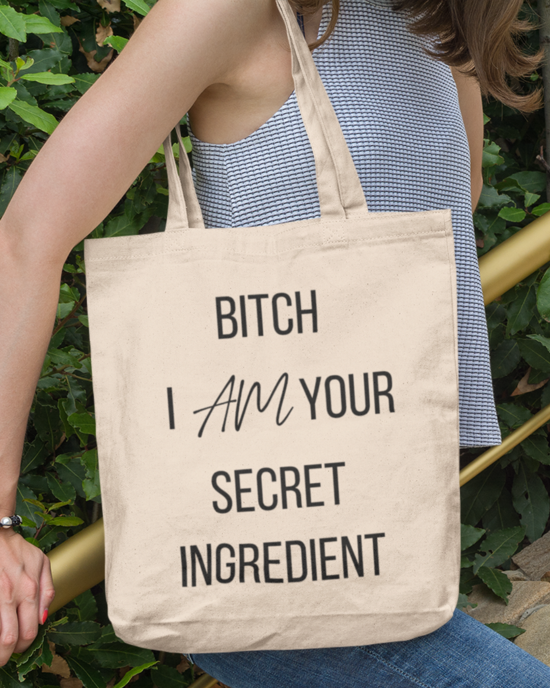 Mom's Canva Tote Bag Natural with Bitch I Am Your Secret Ingredient lettering carried outdoors