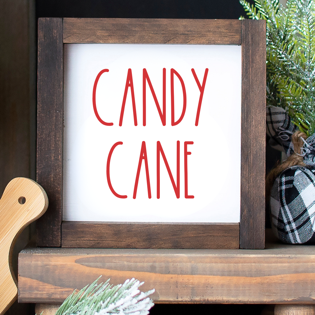 Handcrafted 6x6 rustic wood framed Candy Cane sign styled on a Christmas tiered tray on a white background.