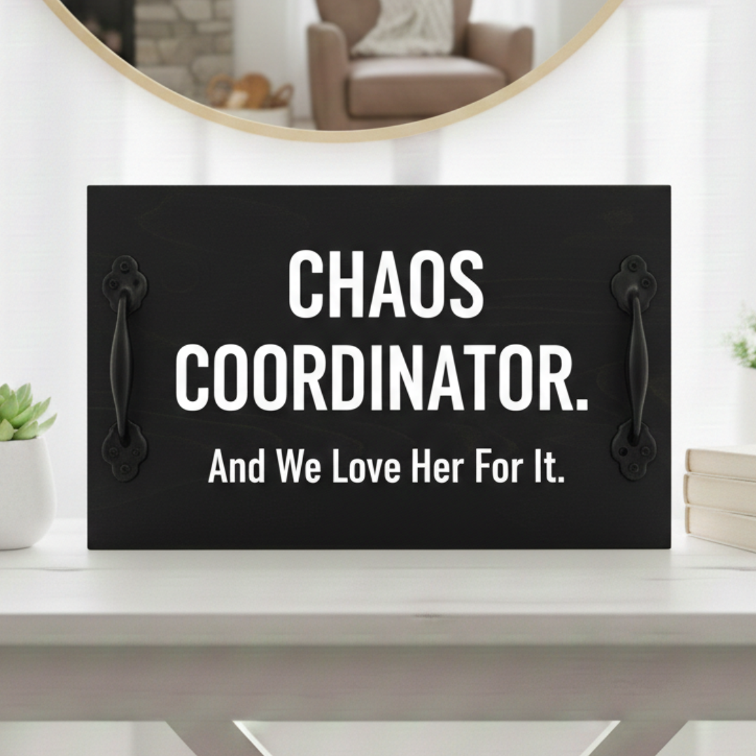 Handcrafted black stained wood sign featuring "Chaos Coordinator" in bold white text with industrial black handles