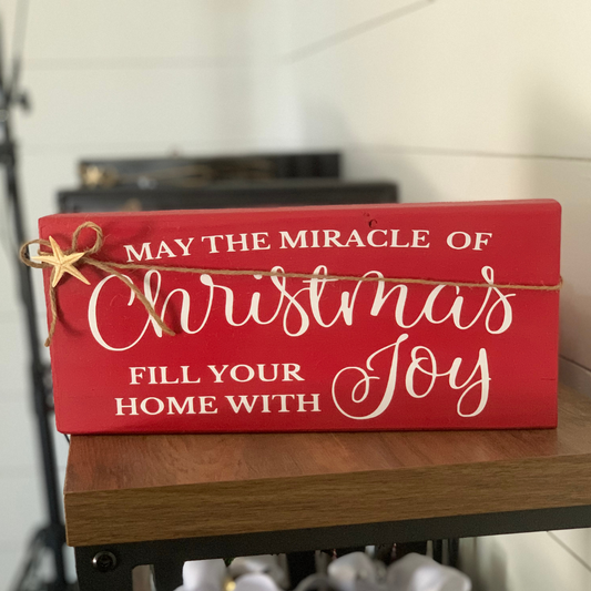 Handcrafted holiday shelf sitter with “May the miracle of Christmas fill your home with joy”