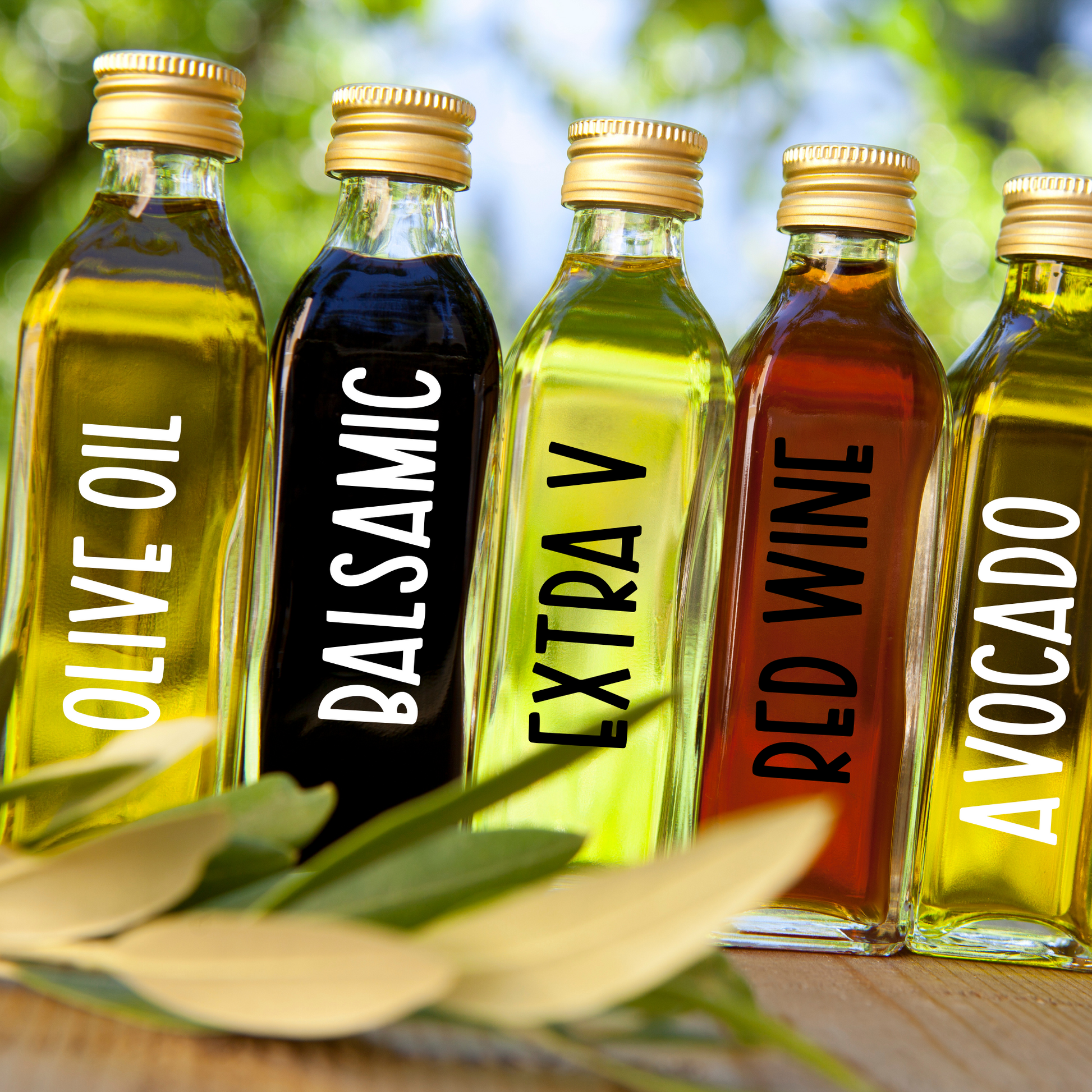 Set of oil and vinegar pantry label decals applied to clear glass jars in a modern kitchen. You can customize it too!