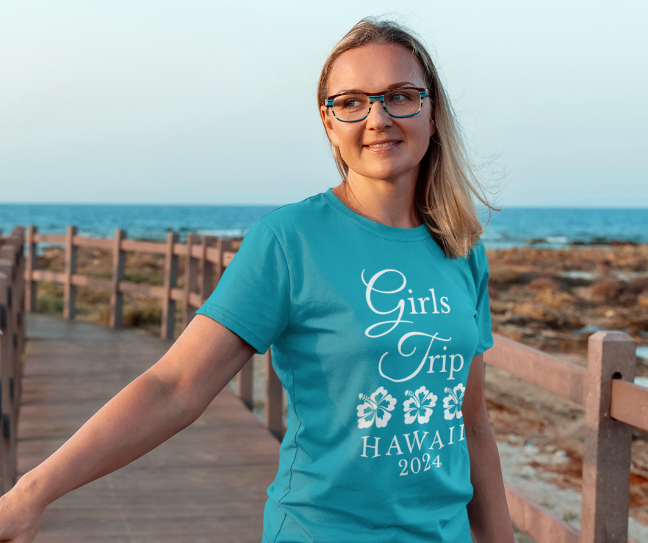 A teen wearing a personalized "Girls Trip" t-shirts on vacation