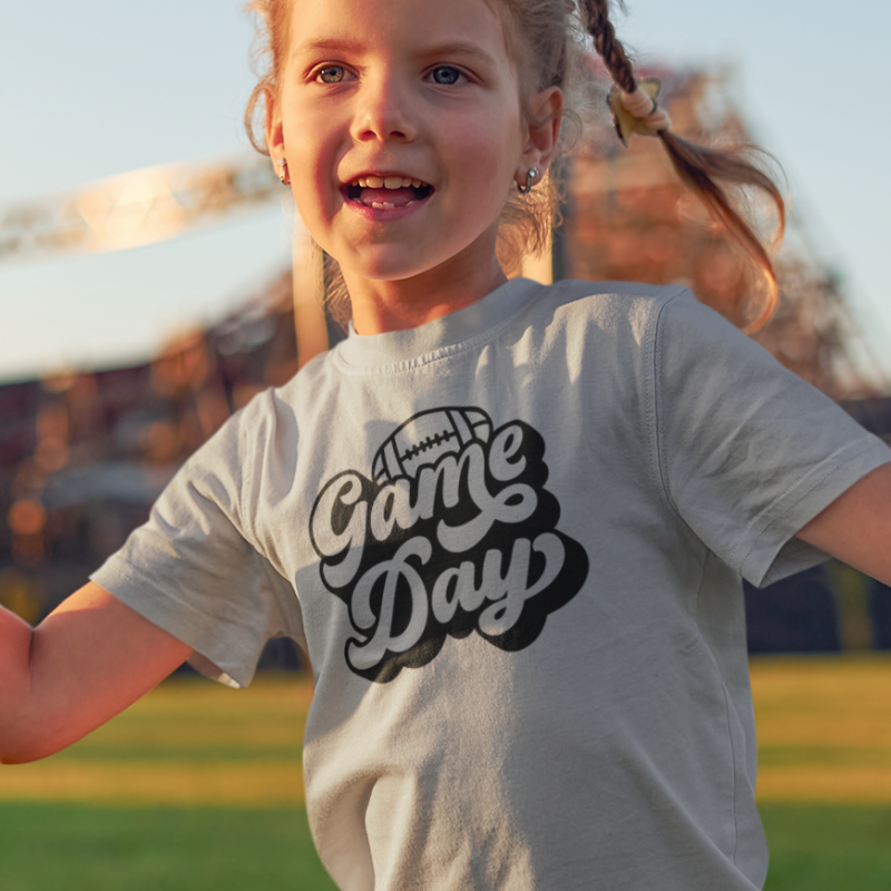 Personalized Kids Girls Grey Double-Sided T-Shirt featuring a football graphic and game day text on the front and a player number on the back, from Simply Aloha On The Go.