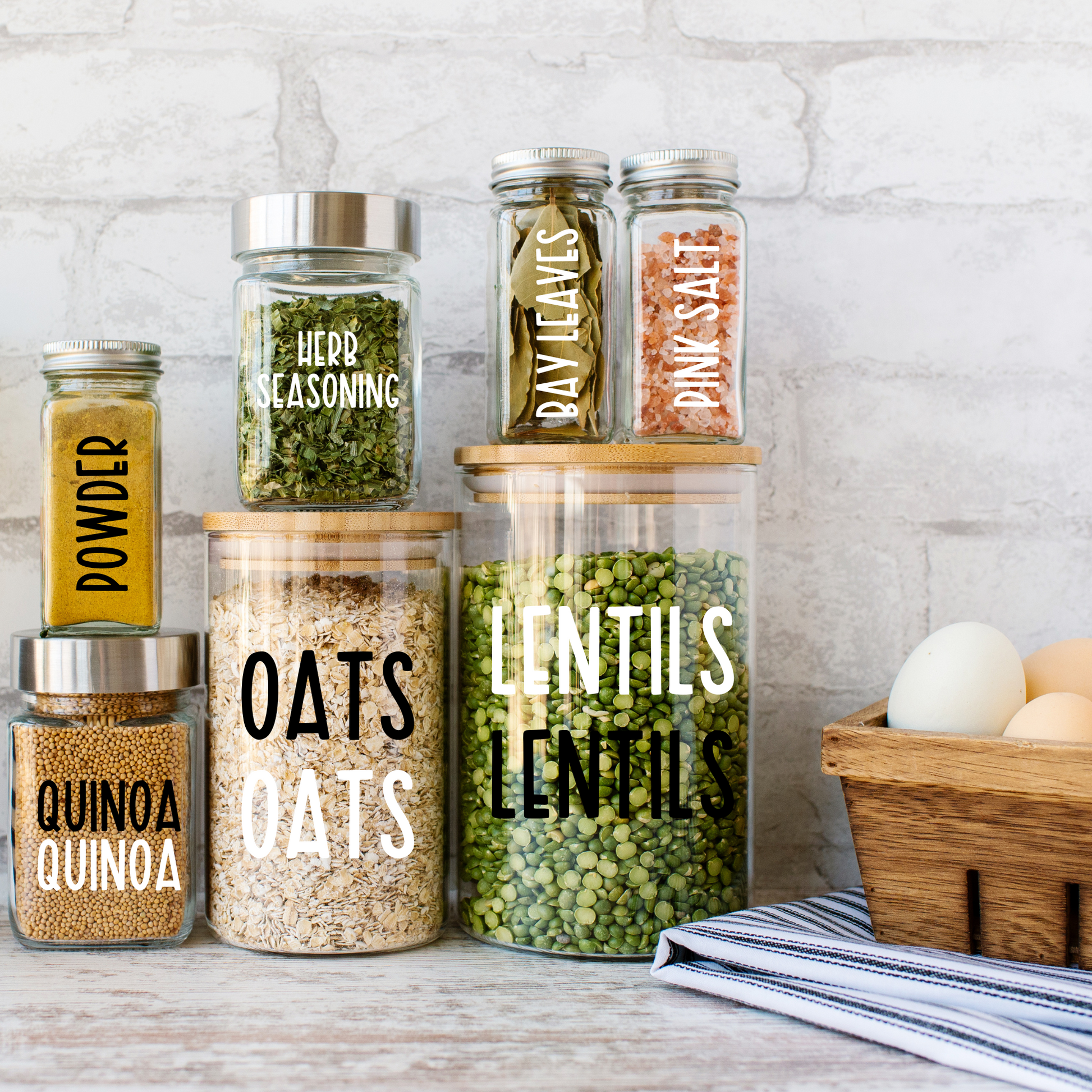 Set of minimalist  pantry and herb seasoning label decals image applied to clear glass jars in a modern kitchen. You can customize your labels too!