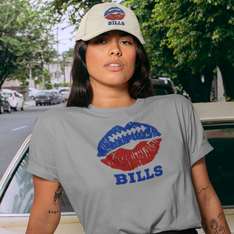 A woman wearing game day t-shirt in grey color with a lip-themed design in blue and red on top and the team name Bills written below. 