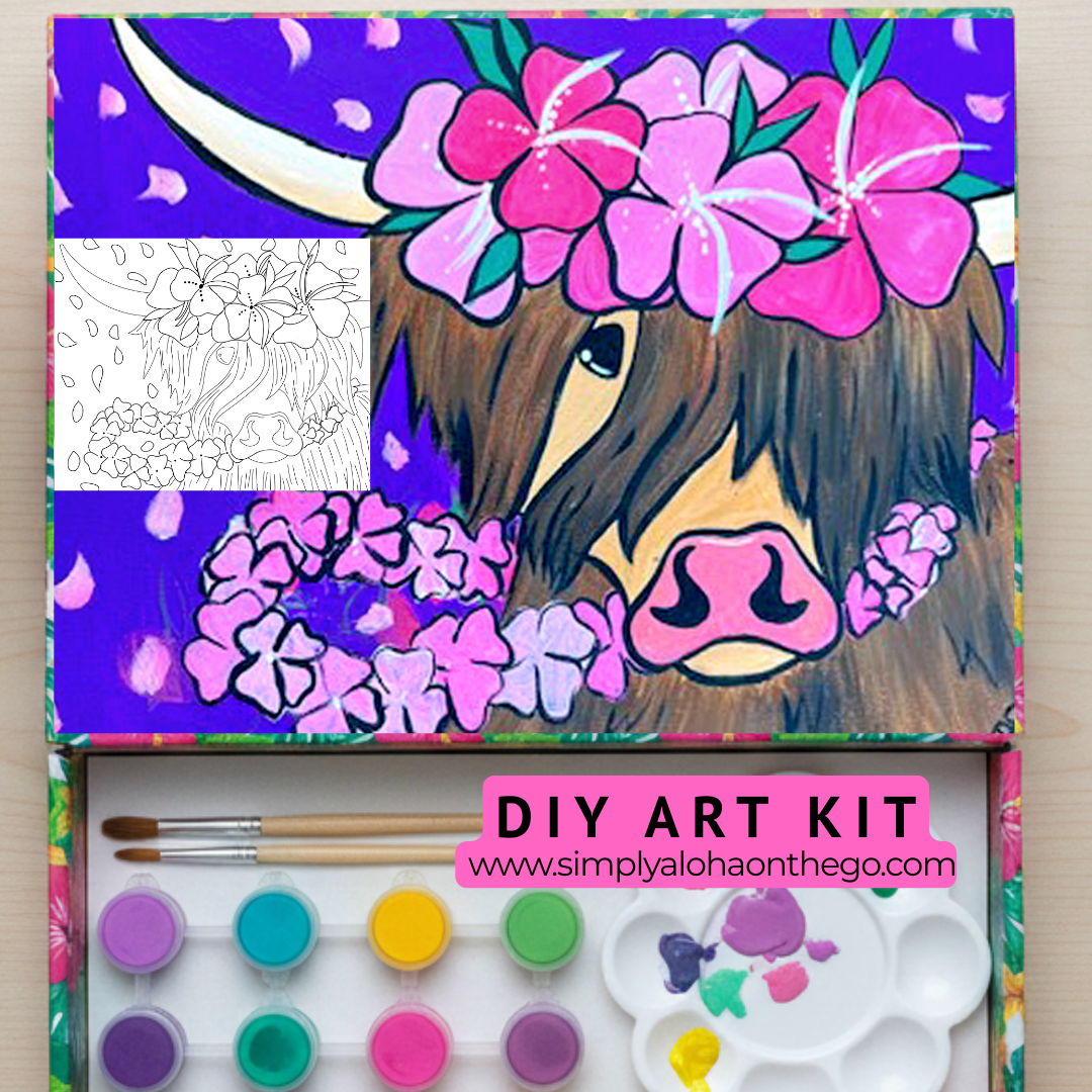 DIY art kit with a colorful highlander cowon canvas and art supplies on a wooden surface.