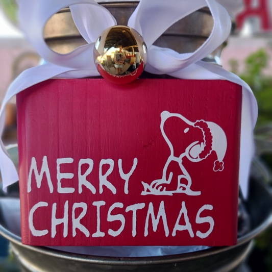 Double-sided 3.75x5 mini sign featuring Snoopy with “Merry Christmas” on one side and a snowflake wood photo holder on the back front side with a snowflke topped with a gold ornament and white ribbon design perfect for holiday 