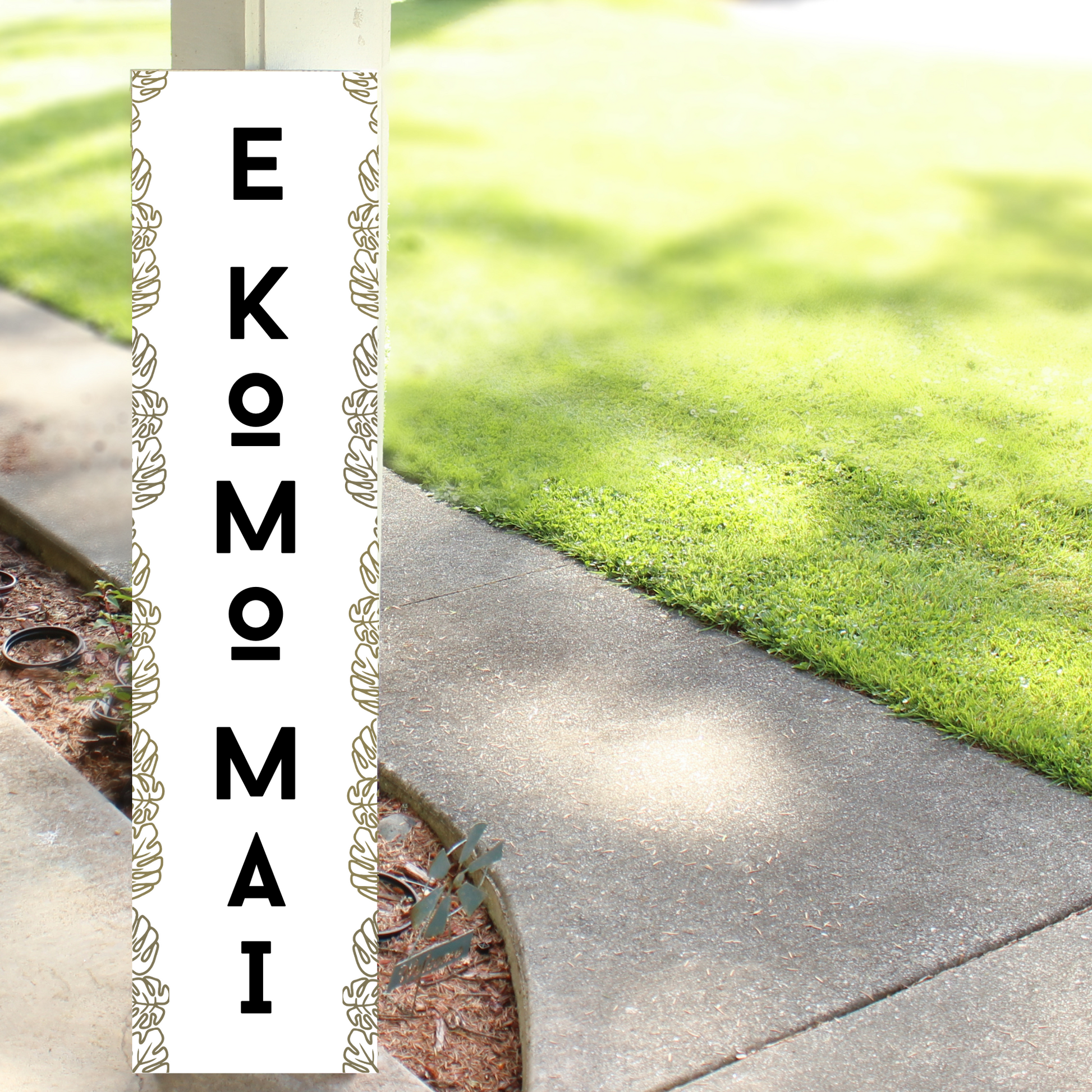 Handcrafted vertical wooden porch leaner with "E Komo Mai" and "Welcome" painted in a rustic Hawaiian style.
