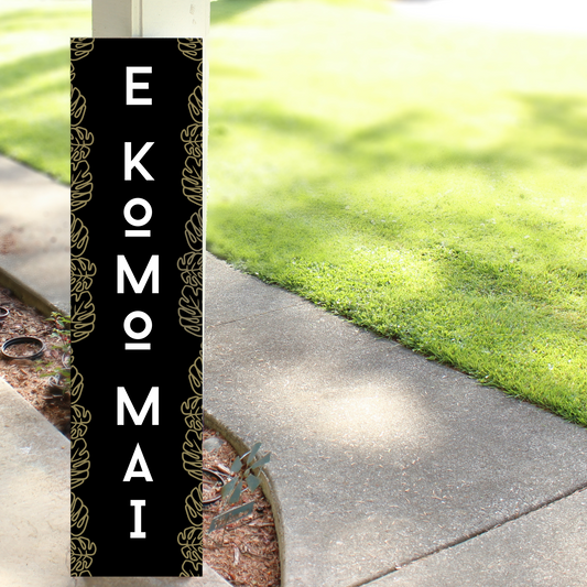 Handcrafted wooden porch leaner with "E Komo Mai" and "Welcome" painted in a rustic Hawaiian style