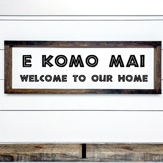 Rustic Hawaiian wood wall sign featuring E Komo Mai and Welcome to Our Home lettering.