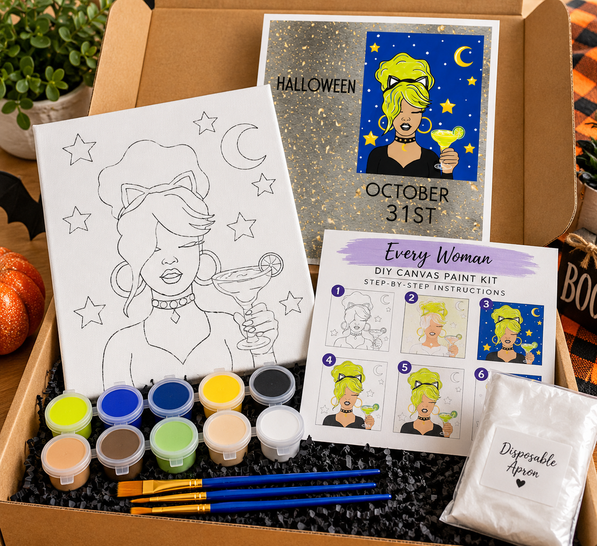 Halloween DIY canvas paint kit featuring a woman with neon green hair and cat ears, pre-outlined canvas, acrylic paints, brushes and disposable apron.