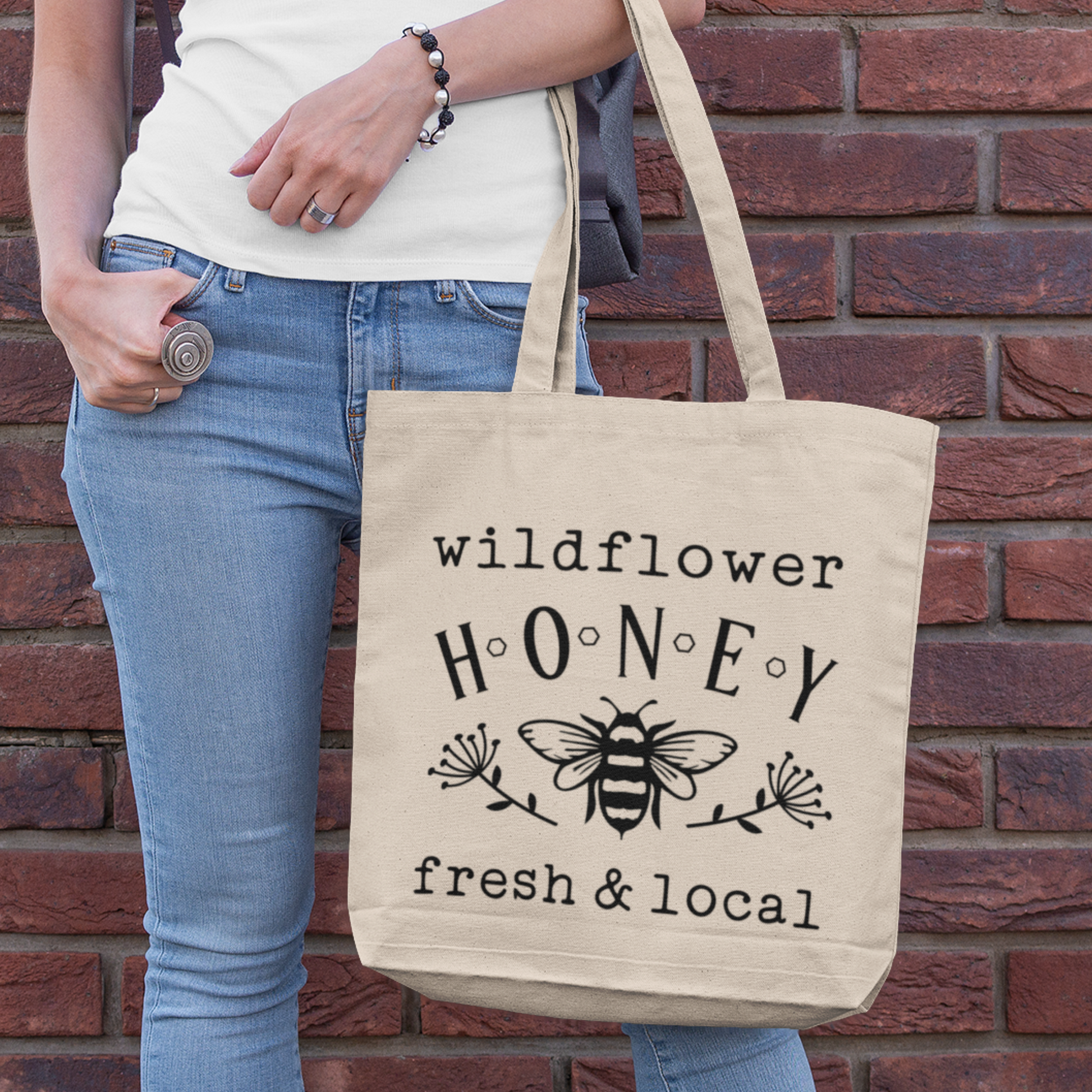 Woman carrying a Simply Aloha Organic Cotton Farmers Market Tote Bag filled with fresh produce.