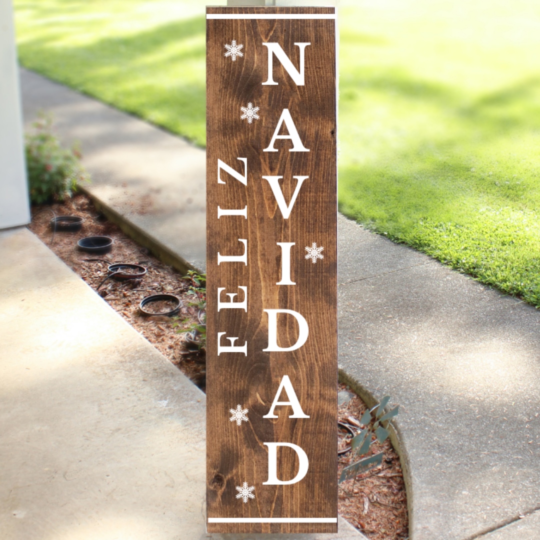 Vertical stained wood Christmas porch sign readingFeliz Navidad with white lettering and snowflake accents, handcrafted by Simply Aloha On The Go