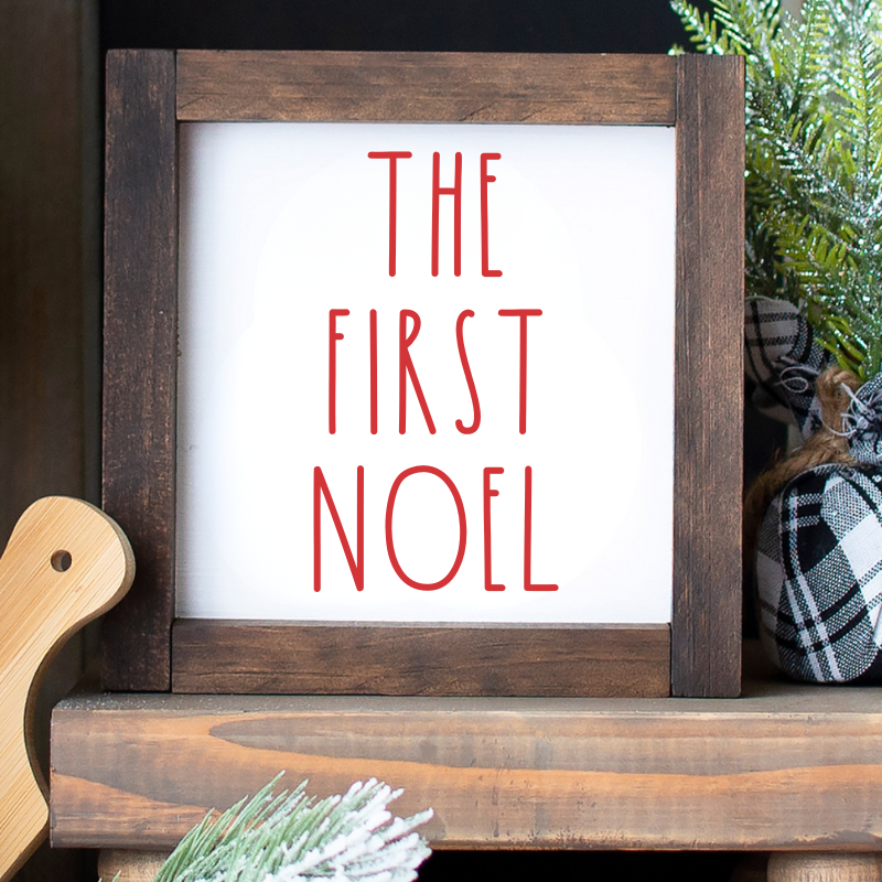closeup of A 6x6 inch handcrafted wooden sign with "The First Noel" in red font on a white background, styled on a tiered tray image shown -Farmhouse Christmas Mini Sign – Custom Shelf Sitter with Mele Kalikimaka, Amazing Grace, First Noel, O Come All Ye Faithful, Dec 25, and O Holy Night