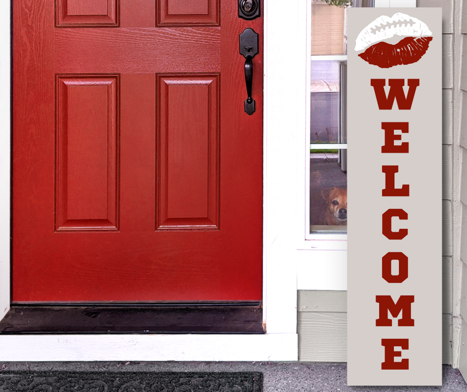Handcrafted 4ft vertical football sign in red, black, and white colors. Features a lip-themed welcome message. Custom Game Day Decor by Simply Aloha On The Go.