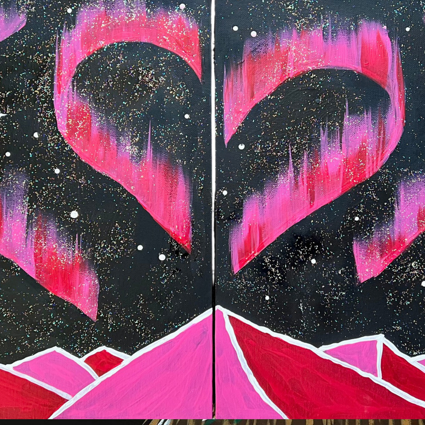 A starry night sky featuring pink and purple aurora borealis shaped like a heart over bright pink mountain peaks.
