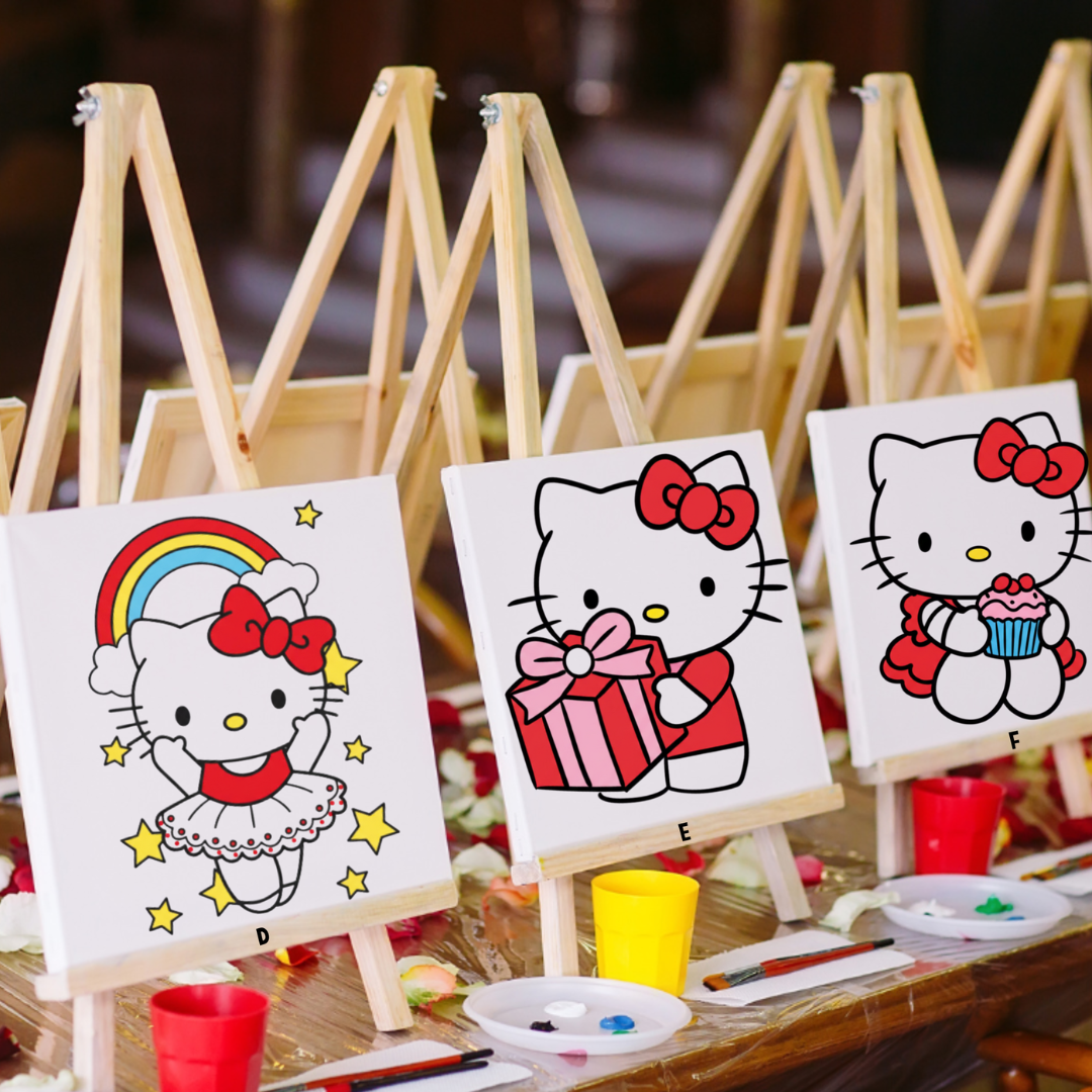 Three pre-drawn Hello Kitty Inspired paint finish canvases on wooden easels ready for a children's paint party perfect for creative parties and gifts for young artists