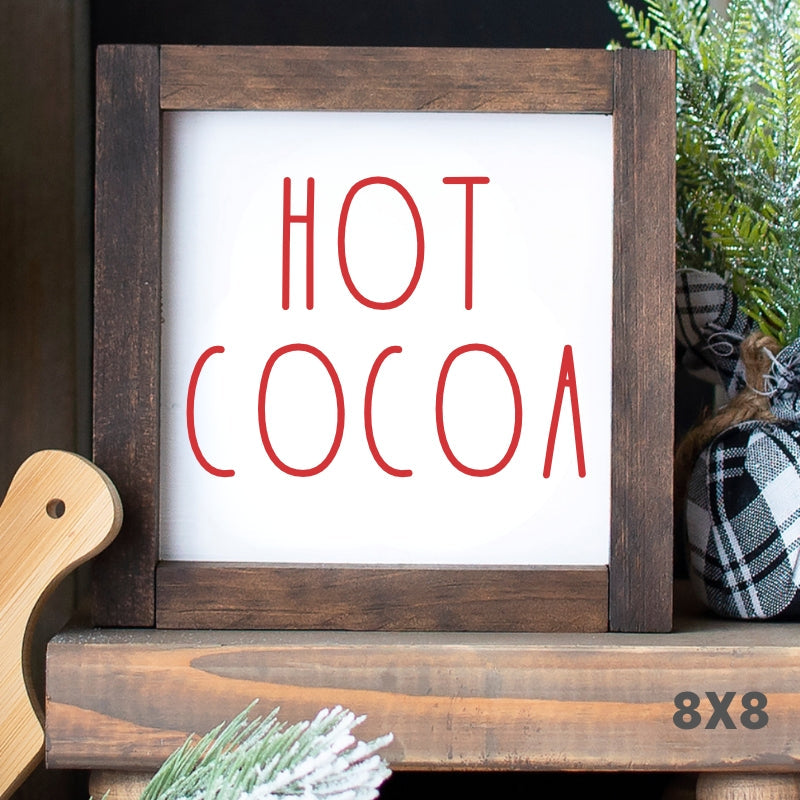 White Hot Cocoa Shelf Sitter Sign with red lettering and rustic wood frame displayed on a Christmas coffee bar.