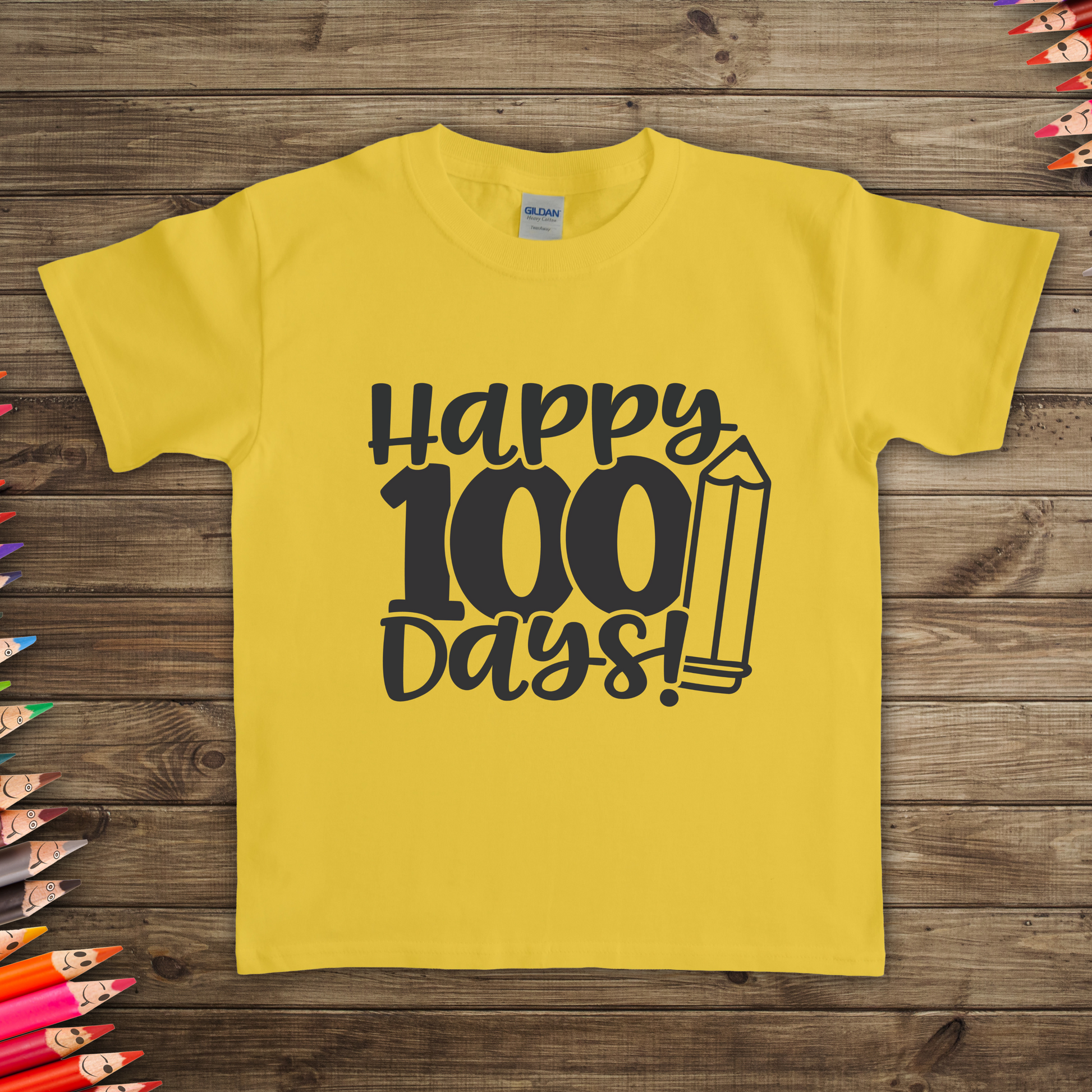 100 Days of School kids t-shirt in  laying on the floor with fun classroom design available in many colors and sizes