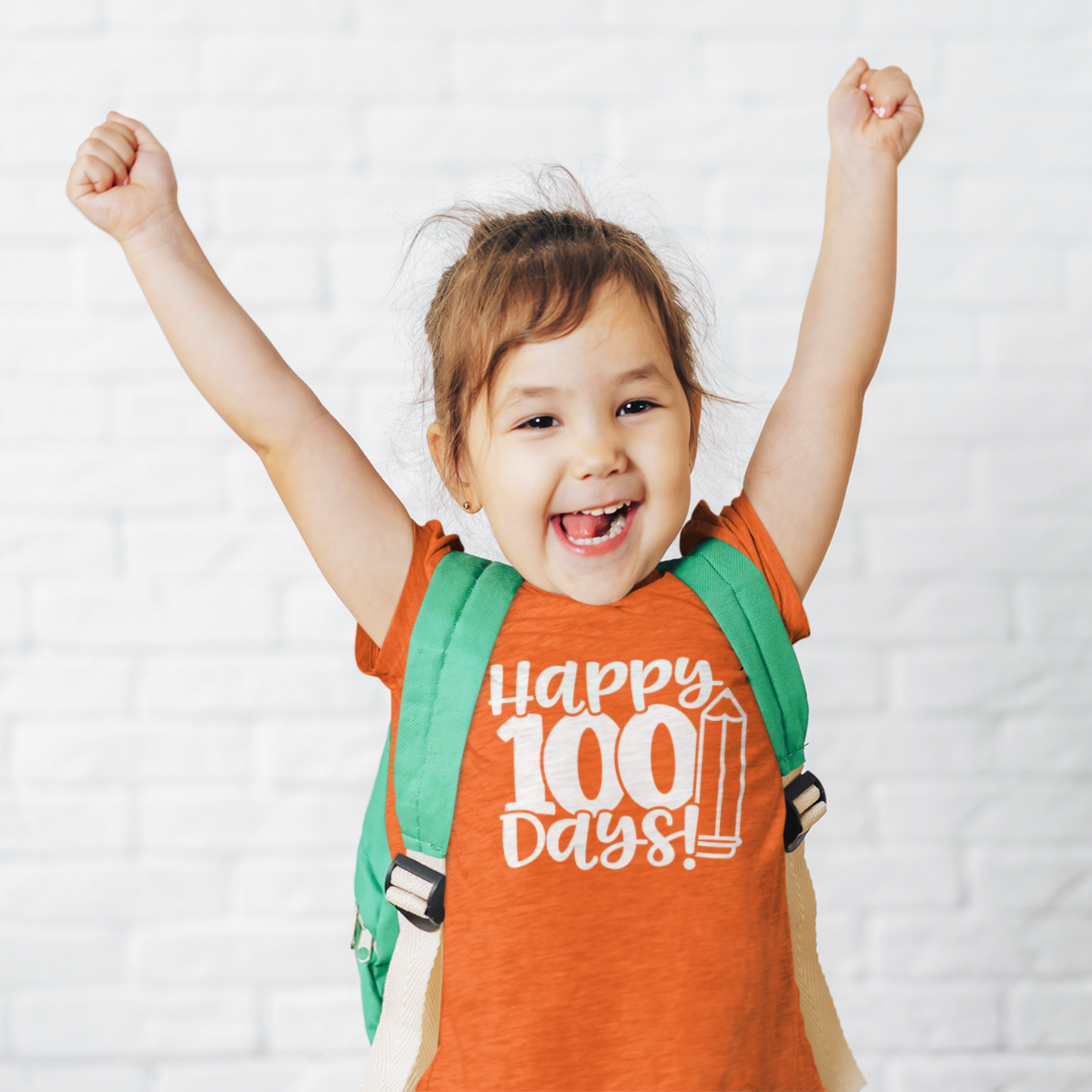 Smiling girl wearing purple Happy 100 Days kids t-shirt with backpack