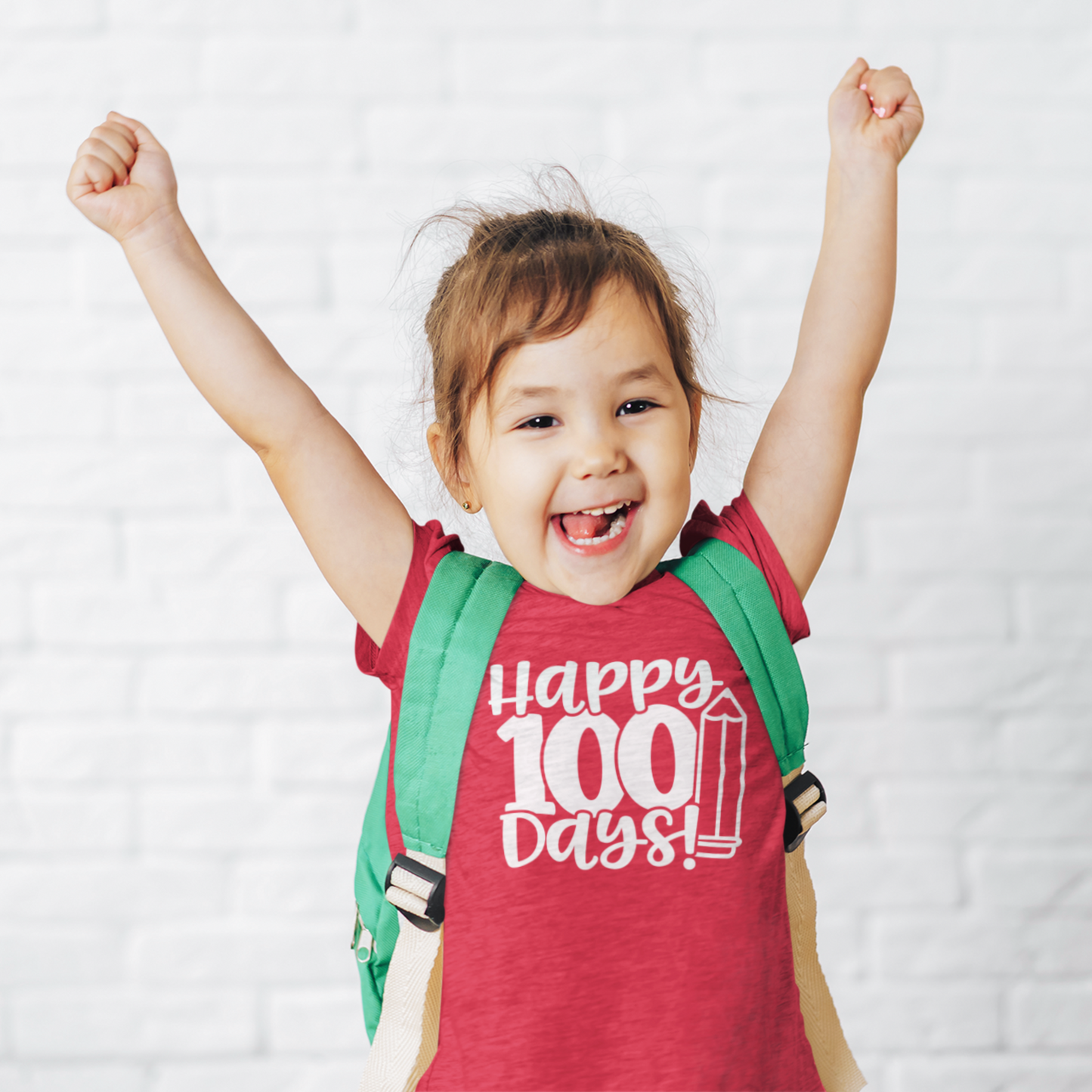 Smiling girl wearing purple Happy 100 Days kids t-shirt with backpack