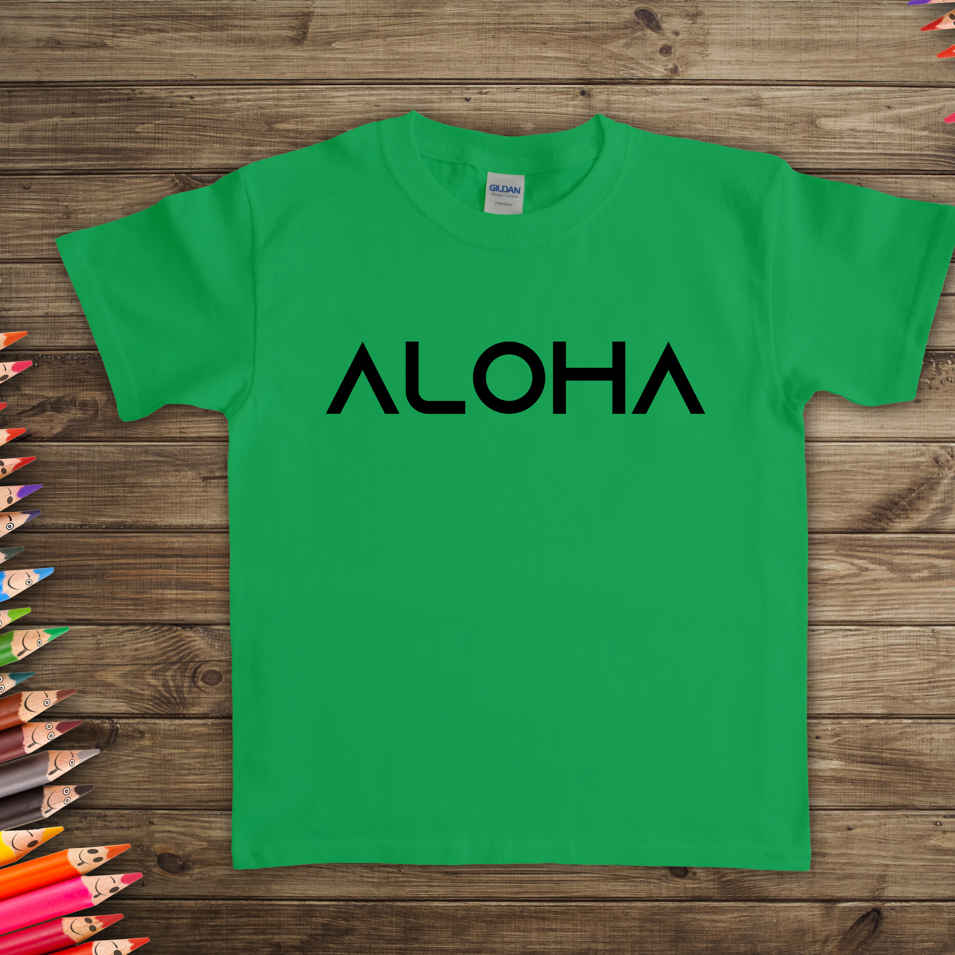 A green kids t-shirt that says "Aloha" in a black font, a Hawaiian-inspired shirt for kids. Available in different colors and sizes