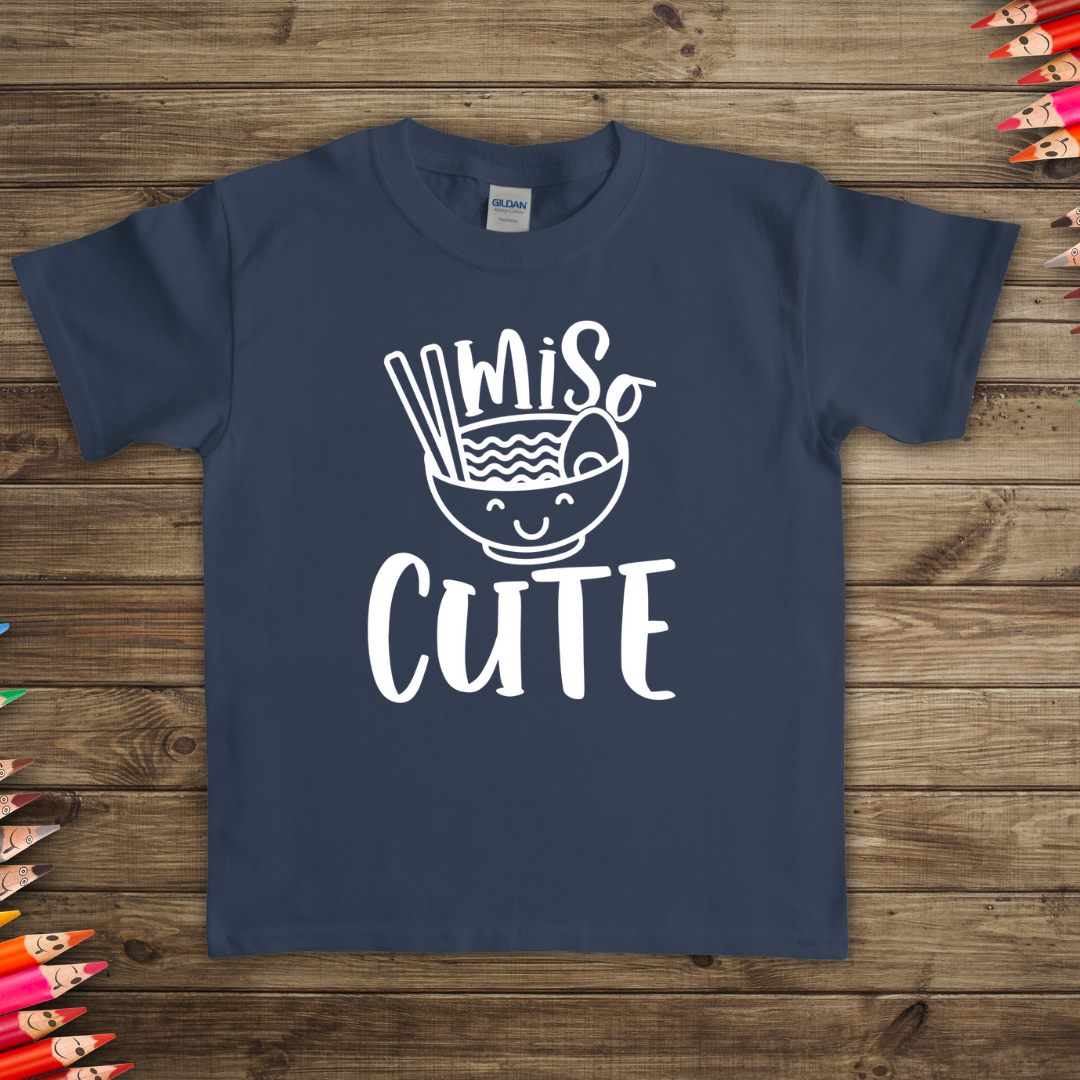 Blue t-shirt with Miso Cute design t-shirt laying on the floor for display available in many color and sizes 