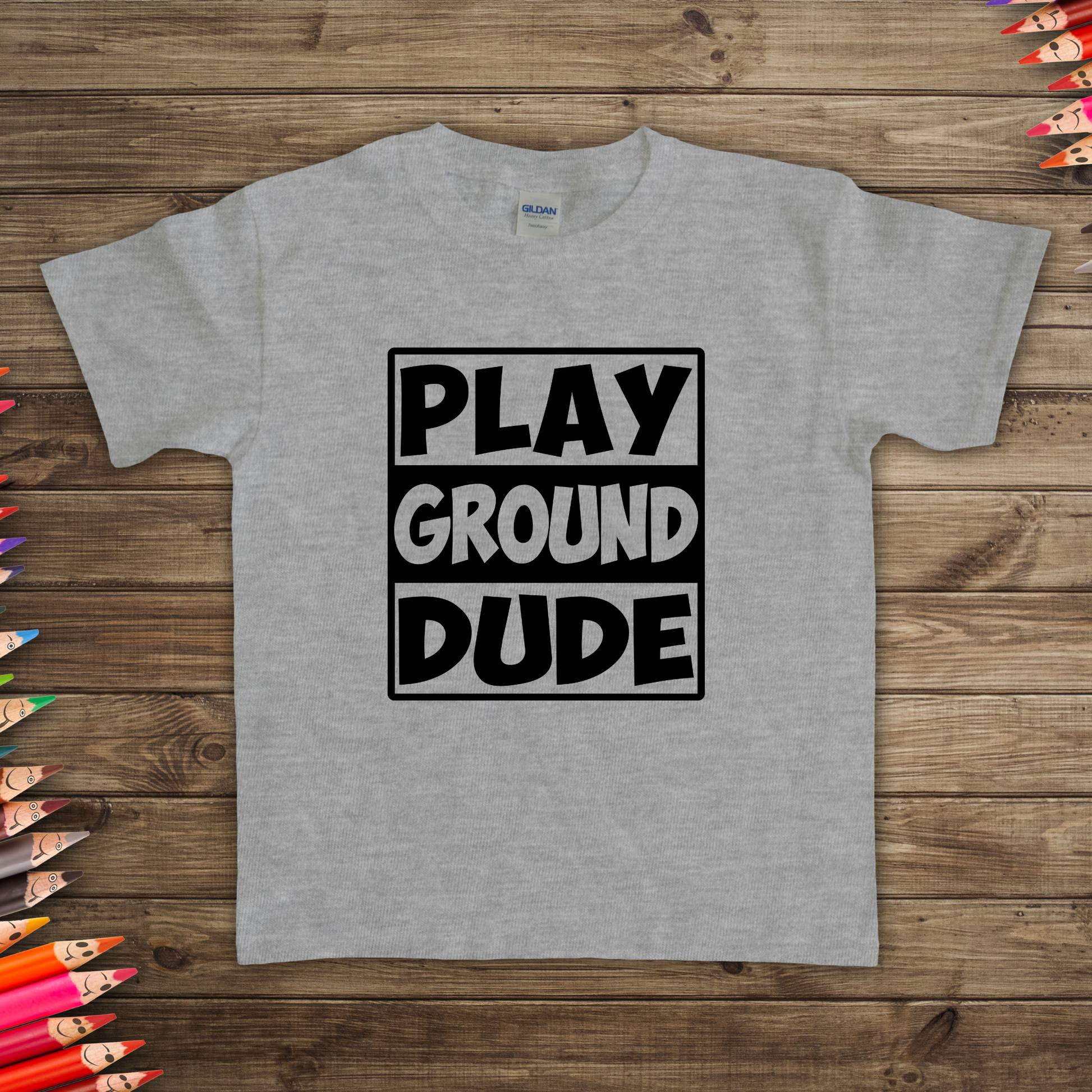 Kids Playground Dude Boys T-Shirt in vibrant colors with a playful design of swings, slides, and merry-go-rounds. Perfect for active play and casual wear.