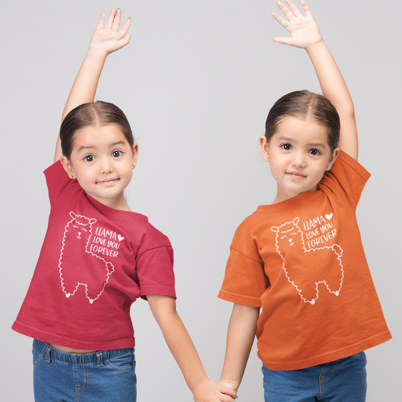 Two children wearing a red and ornage color t-shirts with a llama image design and text that reads Llama Love You Forever on a plain background by Simply Aloha On The Go