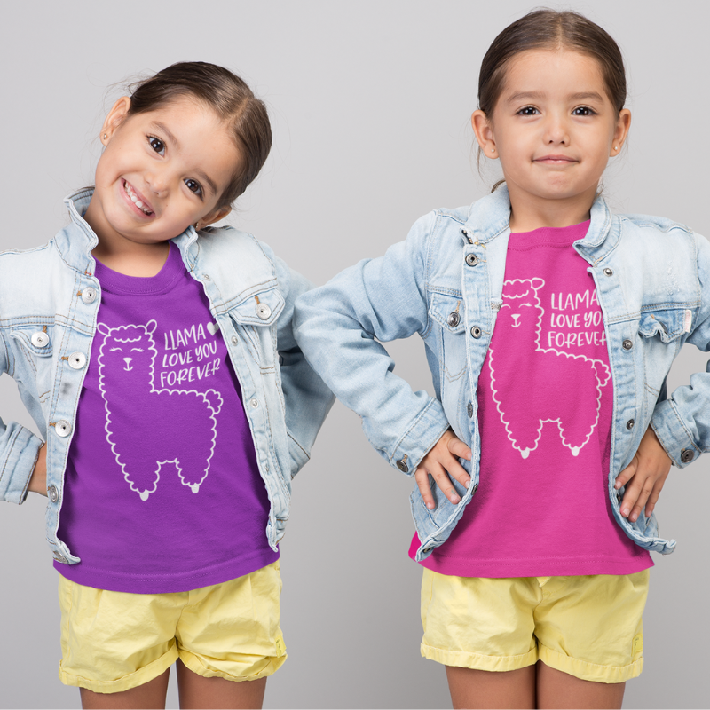 Two children wearing a purple and pink color t-shirts with a llama image design and text that reads Llama Love You Forever on a plain background by Simply Aloha On The Go