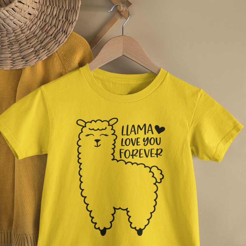 Yellow t-shirt with a llama graphic and text  with a Llama Heart You Forever graphic hanging on a wooden hanger against a beige wall by Simply Aloha On The Go