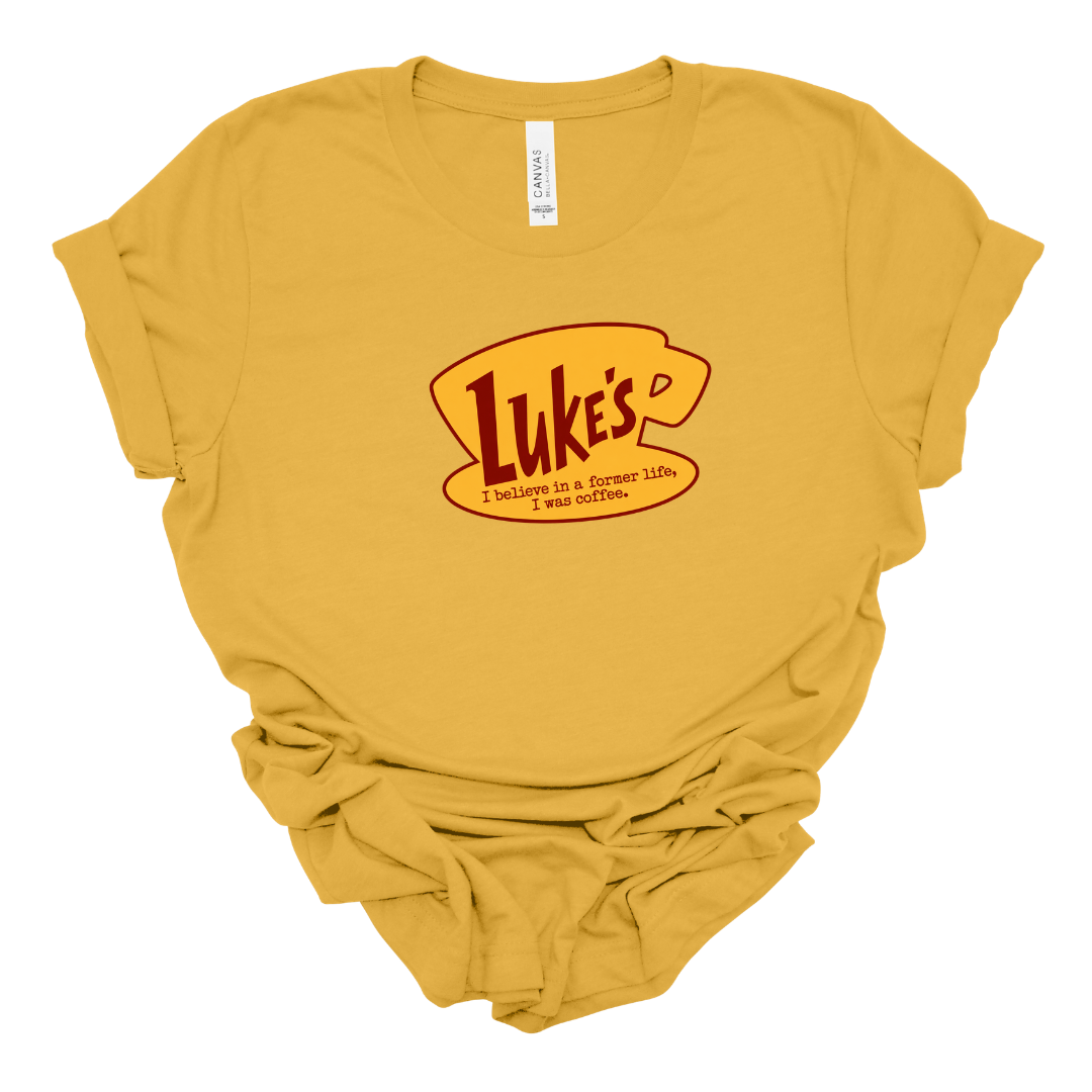 Luke's Diner "I Believe In A Former Life I Was Coffee" Graphic T-Shirt Flat Lay In Mustard – Gilmore Girls Fan Shirt