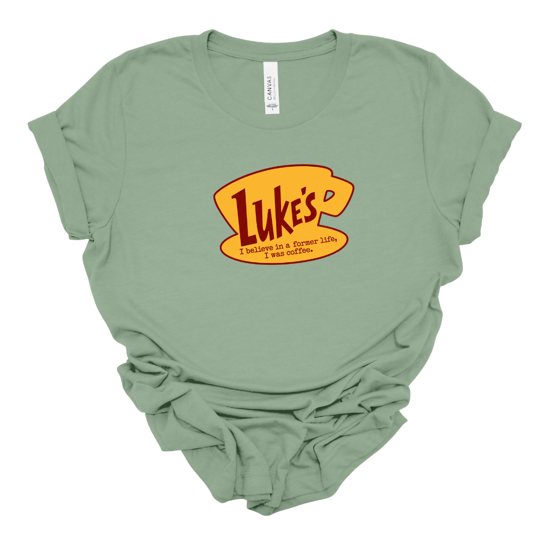 Luke's Diner "I Believe In A Former Life I Was Coffee" Graphic T-Shirt Flat Lay In Sage Green – Gilmore Girls Fan Shirt