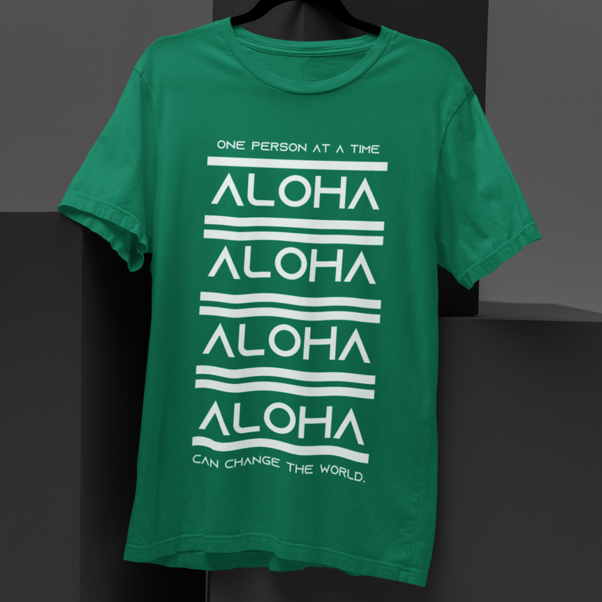 Aloha T-shirt featuring the inspirational message One Person At A Time Can Change The World. This shirt represents the Aloha spirit a perfect reminder of how small actions can make a big difference.