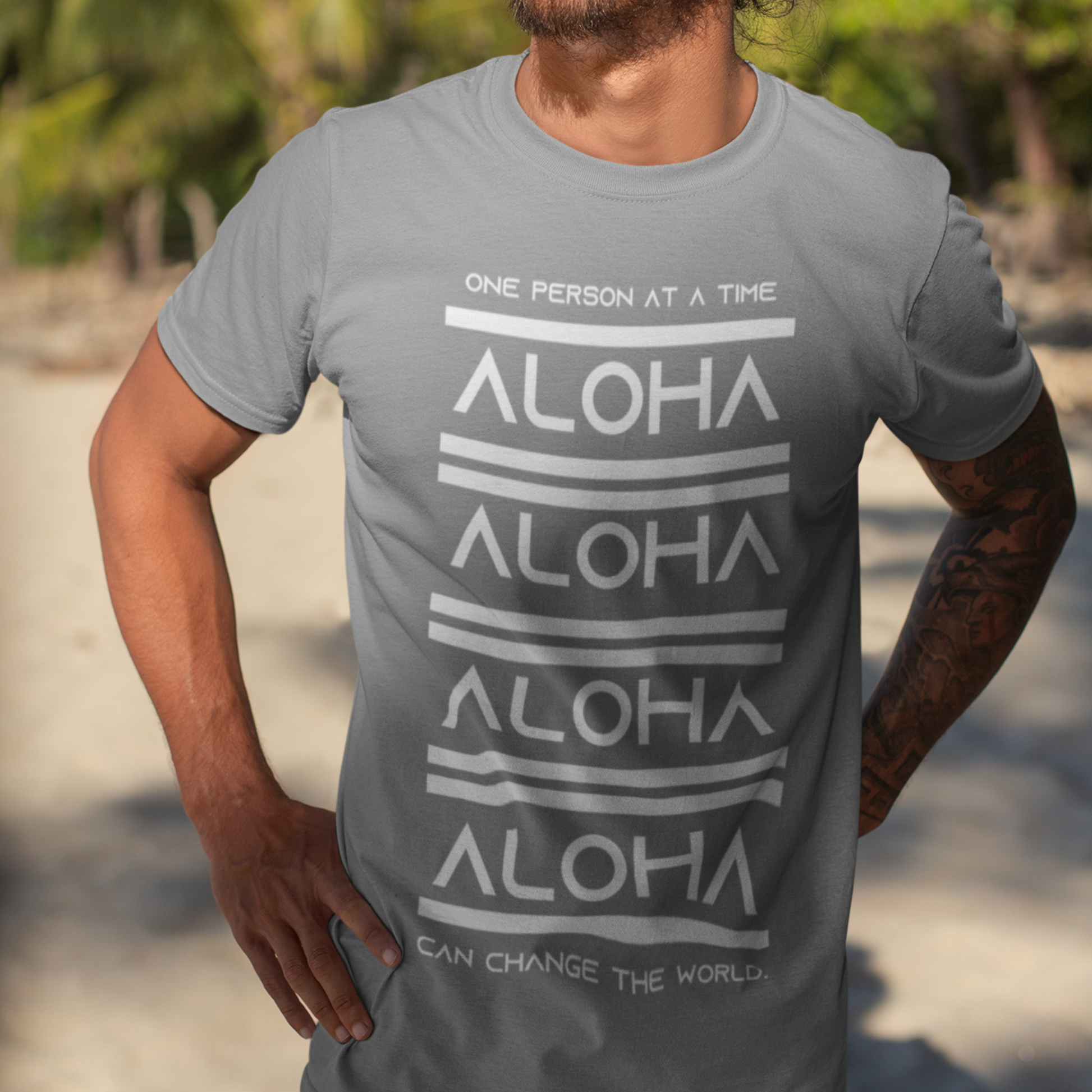 Aloha T-shirt featuring the inspirational message One Person At A Time Can Change The World. This shirt represents the Aloha spirit a perfect reminder of how small actions can make a big difference.