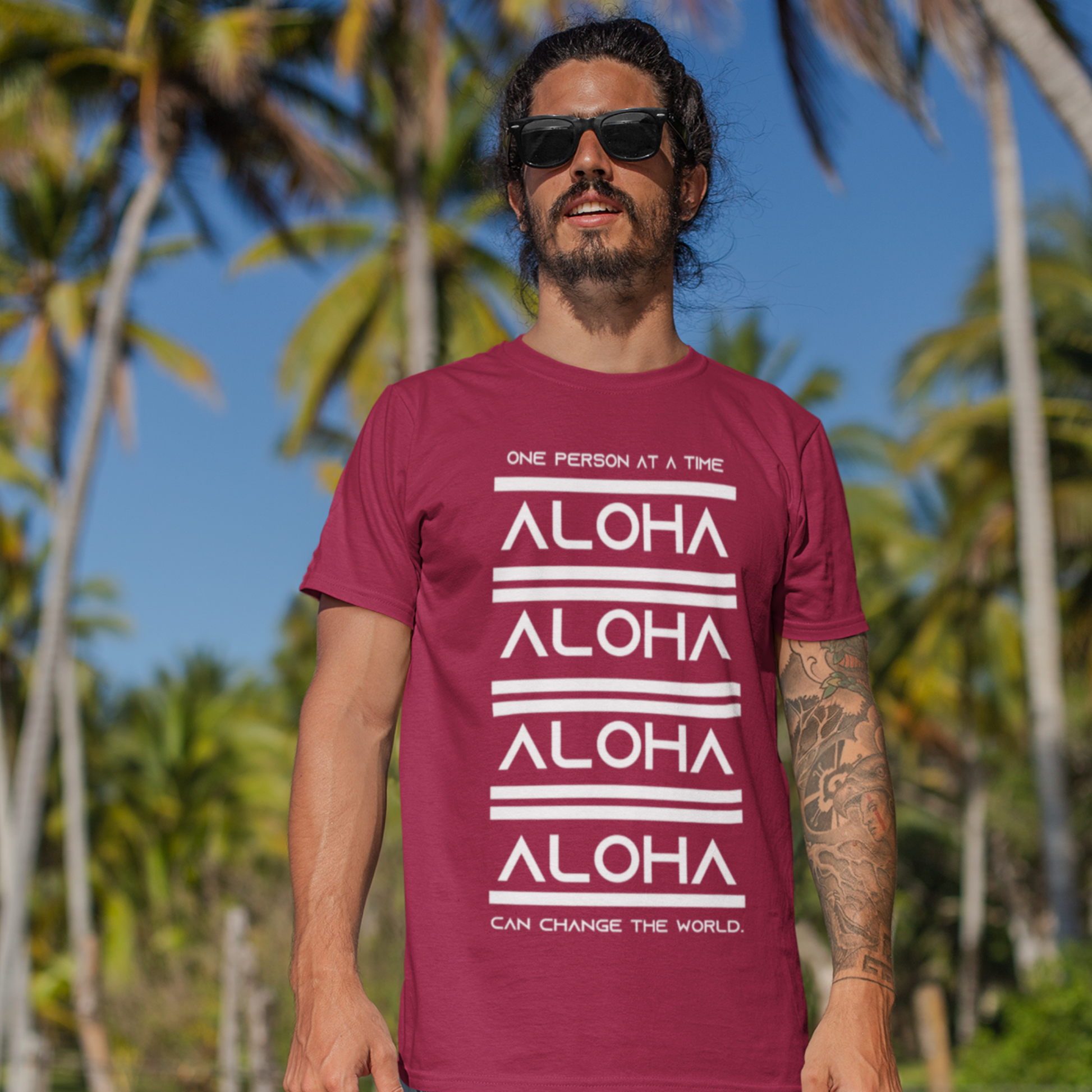 Aloha T-shirt featuring the inspirational message One Person At A Time Can Change The World. This shirt represents the Aloha spirit a perfect reminder of how small actions can make a big difference.