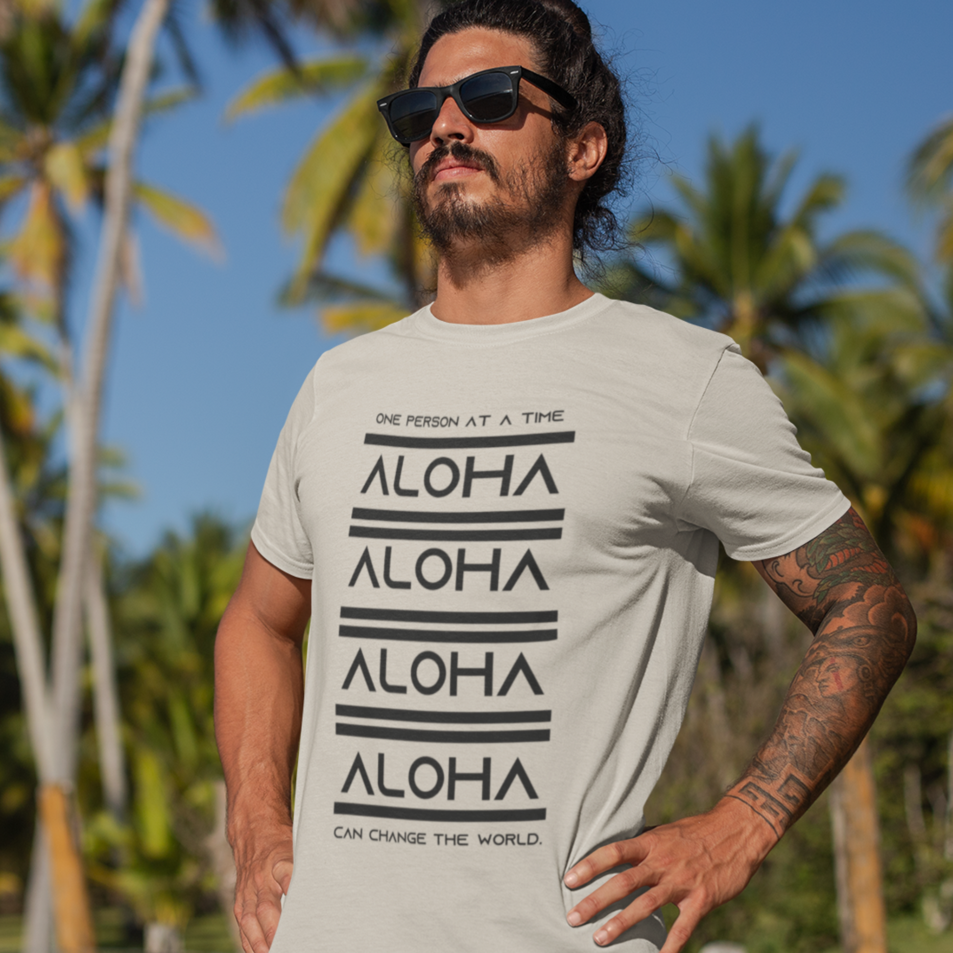 Aloha T-shirt featuring the inspirational message One Person At A Time Can Change The World. This shirt represents the Aloha spirit a perfect reminder of how small actions can make a big difference.