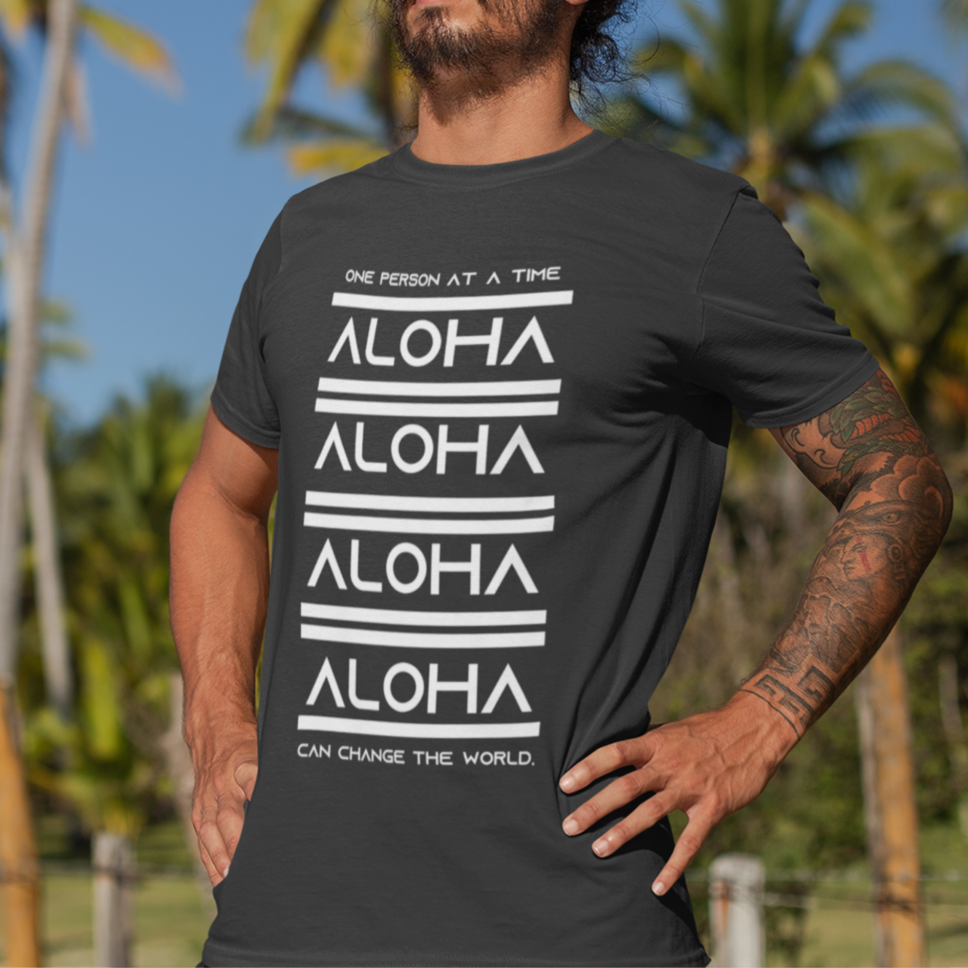 Aloha T-shirt featuring the inspirational message One Person At A Time Can Change The World. This shirt represents the Aloha spirit a perfect reminder of how small actions can make a big difference.