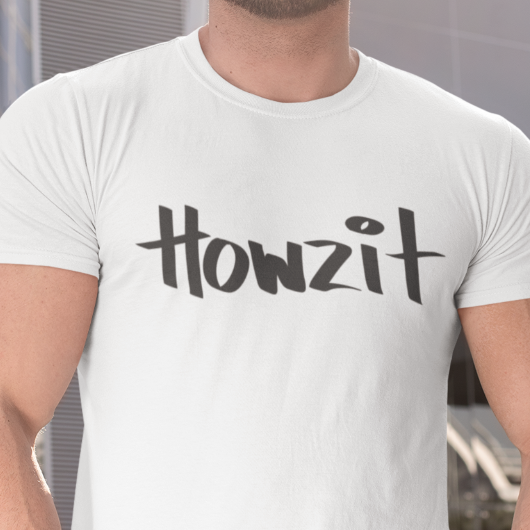 Closeup of a man wearing a white men's t-shirt that says "Howzit" in a simple white font, a Hawaiian slang shirt. Available in different sizes and colors.