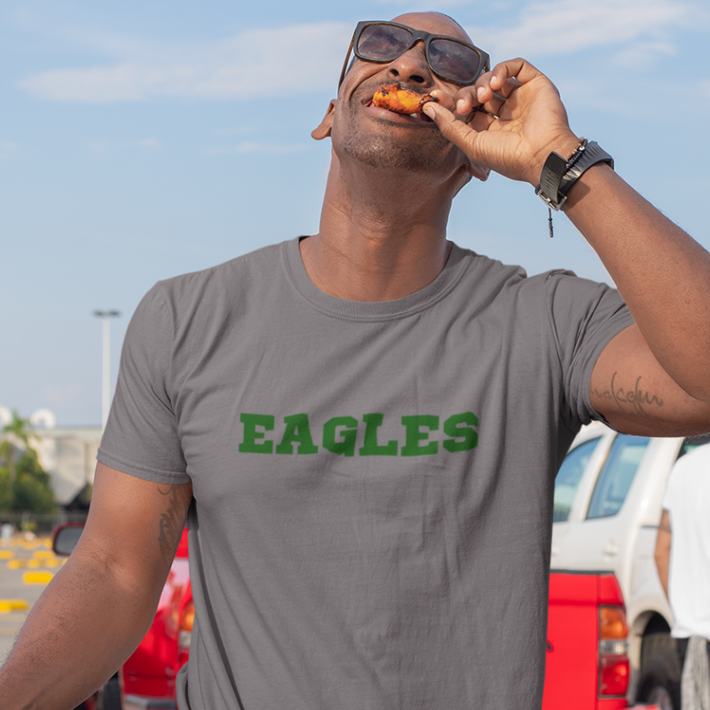 A man at a tailgate wearing a Men’s NFL Game Day T-Shirt printed horizontally with team's name – handcrafted with aloha, PHILADELPHIA EAGLES fan – Simply Aloha On The Go